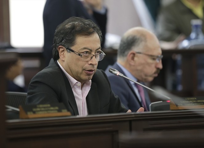 Gustavo petro en una sala de reuniones interviniendo por micrófono