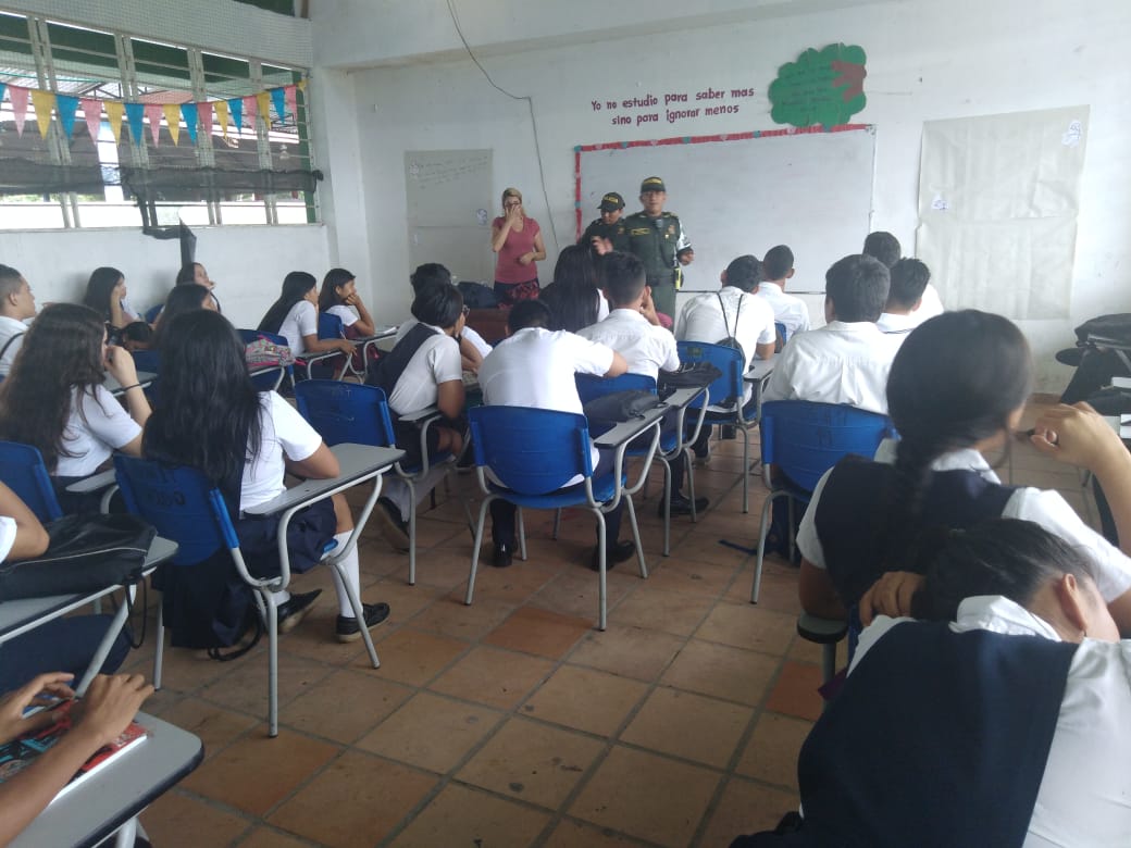 Enseñamos a los estudiantes el uso adecuado del internet Estudiante en aula escuchando personal del policia