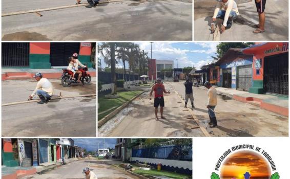 Trabalhos de Pavimentação na Ruas Pessoas medindo rua