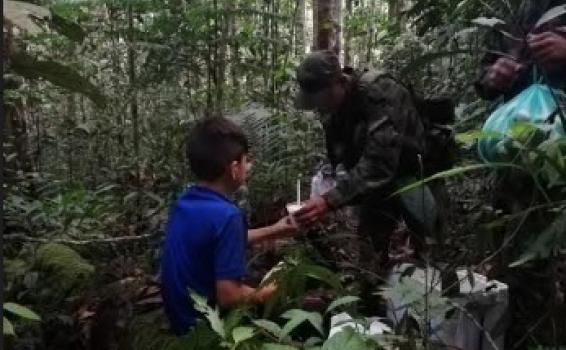 Militares entregando comida a niño en la selva 