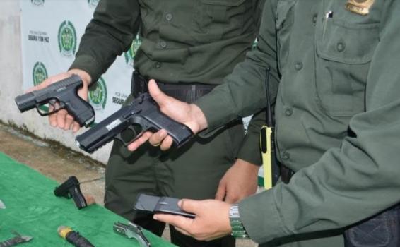 Dos policias sosteniendo cada uno un arma