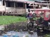 Persona cargando a un niño por el paso de inundaciones 